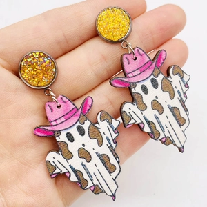 Detail view of wooden ghost earrings with pink cowboy hats and cow print for Halloween