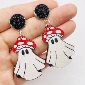 Detail shot of vintage wood mushroom ghost earrings with festive red polka dot pattern