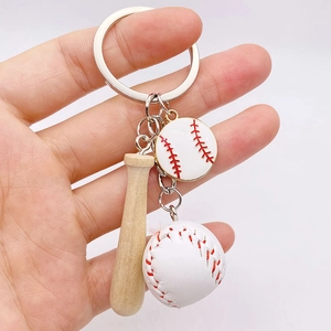 Detailed view of mini baseball keychain set with wooden bat and stitched PU leather ball