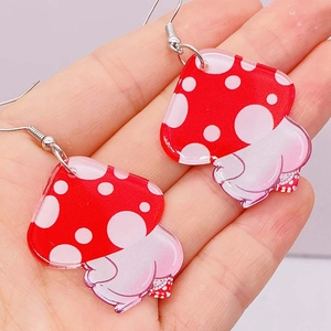 Handheld view of cute acrylic red polka dot mushroom butt earrings with silver hooks