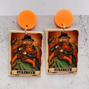 Western tarot earrings featuring the Strength card design with orange stud earrings