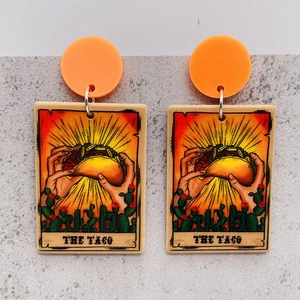 Detail of tarot style earrings featuring hands holding a taco with cactus accents