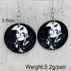 Detail of gothic acrylic earrings featuring witch moon and snake motifs with measurements