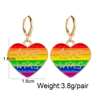 Macro shot of heart-shaped rainbow earrings with Love Wins text and size measurements