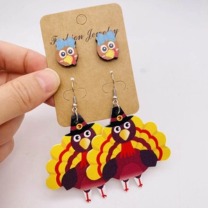 Detail of Thanksgiving turkey earrings set with hand-painted wood studs and dangles