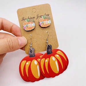 Thanksgiving earring set with leather pumpkin drops and Gobble studs on a display card
