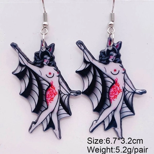 Detail shot of gothic acrylic earrings showing bat wings and tattoo style design