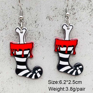 Macro detail of acrylic Christmas earrings with bone leg and black white striped socks
