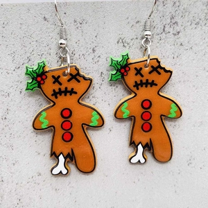 Detail shot of zombie gingerbread man acrylic earrings with silver hooks for Christmas