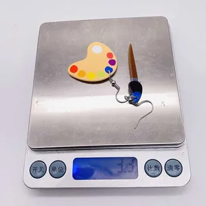 Detailed scale view showing the 3.3g lightweight acrylic painter theme earrings