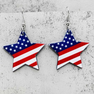Macro detail of acrylic star earrings featuring American flag patterns with silver hooks