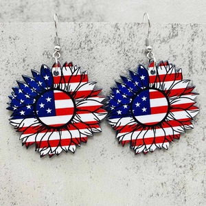 Detail of USA flag sunflower earrings featuring red white stripes and blue stars patterns