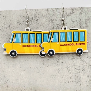 Detail of yellow school bus acrylic dangle earrings with silver metal hooks for teachers
