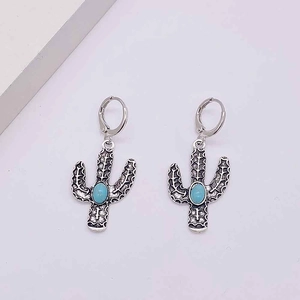 Detailed view of bohemian cactus hoop earrings with turquoise stones and vintage silver finish