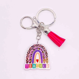 Acrylic teacher rainbow keychain with leopard print and pink tassel on white background
