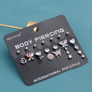 Detail of seven unique navel rings with cubic zirconia charms on black display card
