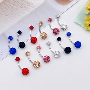 Close-up of multicolored Shamballa crystal belly rings set in stainless steel