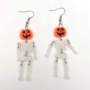 Luminous Halloween pumpkin skeleton drop earrings with articulated skull dangling limbs