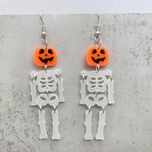 Detailed view of Halloween dangling earrings featuring orange pumpkin and articulated skeleton