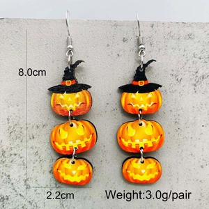 Detail showing tiered orange pumpkin earrings with witch hats and size measurements