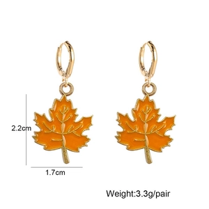 Detail of orange maple leaf earrings with golden alloy frame and exact dimensions