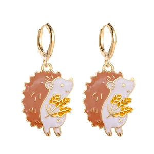 Detail of hedgehog earrings with gold wheat accent and colorful enamel finish