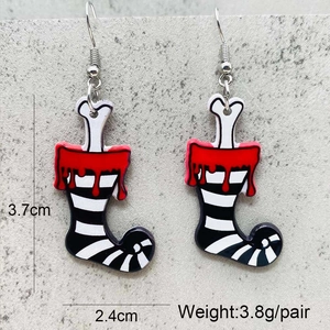 Detail of Halloween drop earrings with bone, blood drip, and striped leg patterns