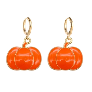 Detailed macro view of orange pumpkin enamel drop earrings with golden metal ring hooks