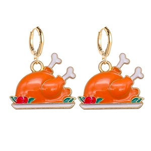 Detail of creative Thanksgiving roasted turkey earrings with colorful enamel finish