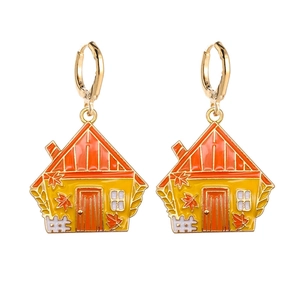 Detail of fall-themed cottage earrings with maple leaf accents and enamel finish