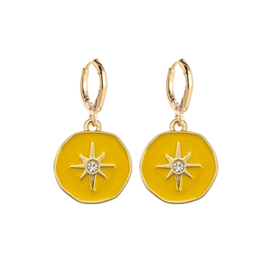 Detail of gold octagon earrings with bright yellow enamel and sparkling center starburst