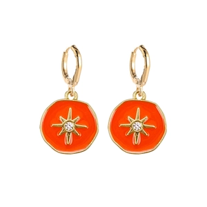 Detailed view of orange enamel hoop earrings with golden starburst and central crystal
