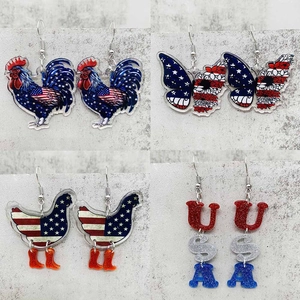 Detail of four acrylic patriotic earrings featuring stars, butterflies, and USA letters