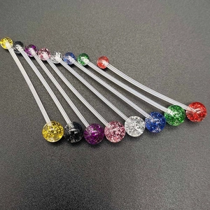 Detailed macro view of flexible UV acrylic belly bars with sparkling glitter balls in various colors