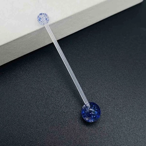 Detail of acrylic industrial piercing bar with blue glitter star balls and clear rod
