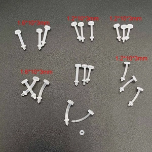 Macro shot of clear flexible bio-plastic lip studs in various sizes on black background