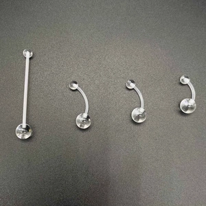 Set of four transparent acrylic body piercing rings including belly bars and straight studs