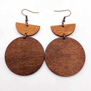 Close-up of vintage geometric wooden earrings with natural walnut grain and bronze hooks