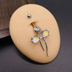 Detailed macro view of silver navel piercing with colorful pear-shaped opal stones