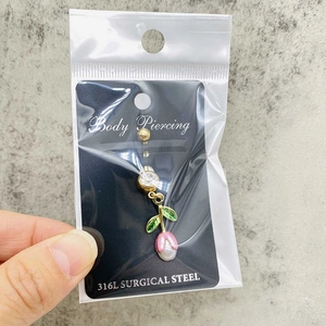 Detailed macro view of 316L surgical steel belly ring with tulip flower design