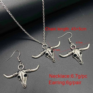 Detailed view of bull skull jewelry set with necklace and earrings size measurements