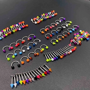 Macro shot of assorted acrylic piercing jewelry set with colorful balls and spikes