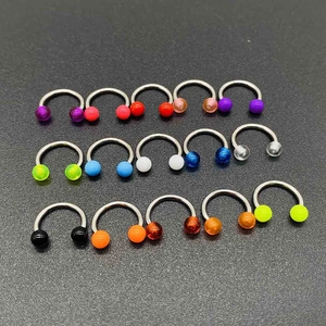 Close-up of 15 colorful horseshoe piercing rings with vibrant acrylic beads on dark background