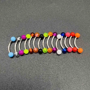 Close-up of colorful acrylic curved barbells for eyebrow, navel, or lip piercings
