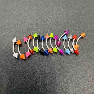 Macro detail of assorted colorful cone curved barbells for eyebrow and ear piercings