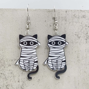 Cartoon mummy cat acrylic drop earrings for Halloween gifts on a textured gray background