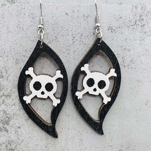 Detail of wooden Halloween S-shape earrings featuring skull and crossbones design