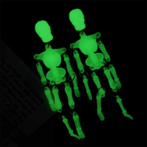 Glow-in-the-dark green skeleton earrings with movable joints for Halloween