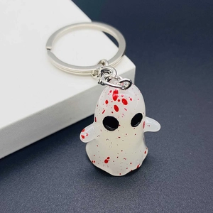 Close-up of translucent white ghost keychain with red blood splatter and metal ring