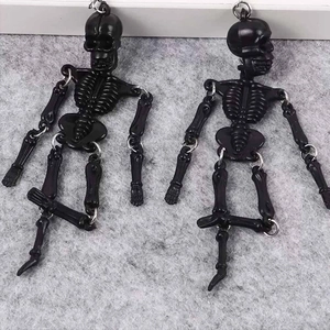 Detail of movable joints on black gothic skeleton earrings for Halloween jewelry style